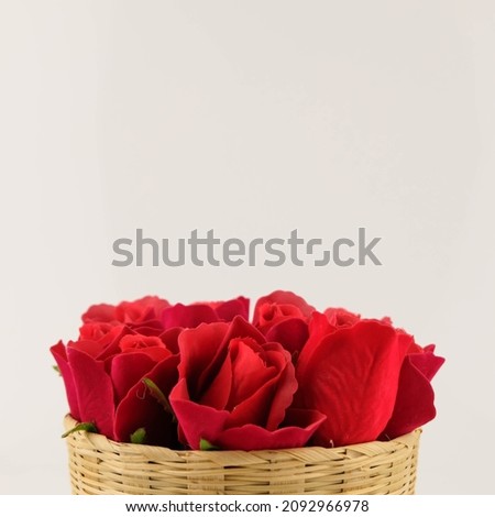 Rattan props placed on a white background and a basket of red roses. For texture background of food products. The ideal backdrop for product presentations, exhibitions and mockups.