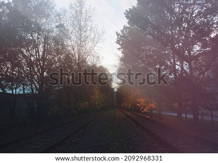 Empty vintage railroad tracks with light rays