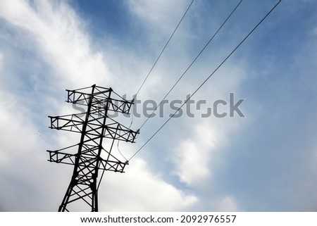 Electricity transmission pylon with beautiful sunset sky background.