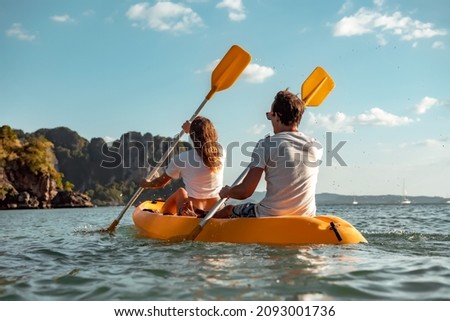 Sea kayaking or canoeing concept with young couple kayakers at tropical bay. Phranang bay, Krabi, Thailand Royalty-Free Stock Photo #2093001736