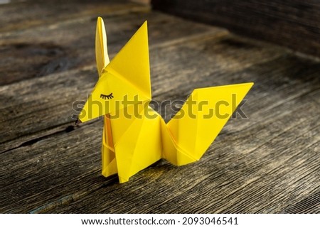 A fox origami with wooden background