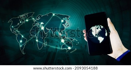 Young man using a cellphone app to looking at airplanes route over around world map with virtual screen background Royalty-Free Stock Photo #2093054188