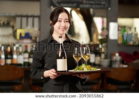 Asian female working in a restaurant Royalty-Free Stock Photo #2093055862