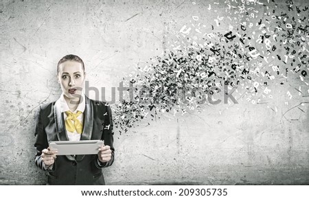 Young shocked woman holding tablet pc in hands and letters flying around