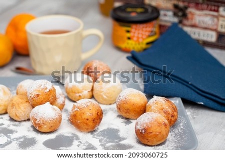 tea drinking with cottage cheese donuts in powder, breakfast with tea and pastries, dessert made at home