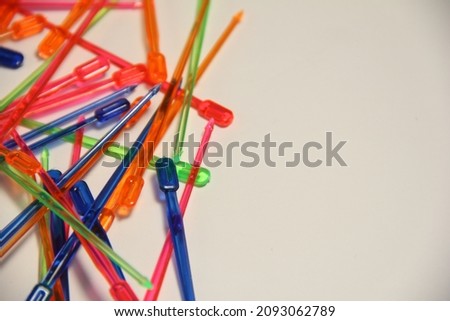 Multicolored plastic skewers. On a white background.