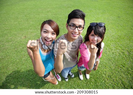 happy students in campus showing fist sign, asian