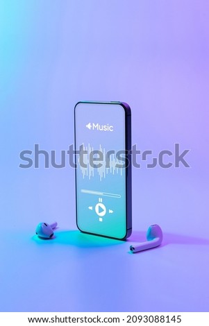 Music banner. Mobile smartphone screen with music application, sound headphones. Audio voice with radio beats on neon gradient background. Broadcast media music banner with copy space