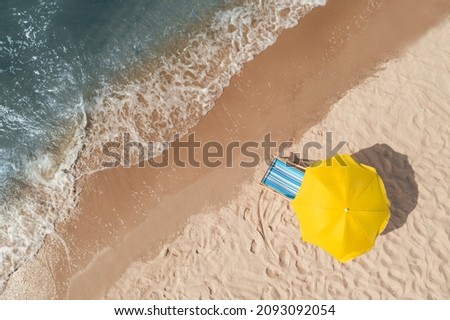 Yellow beach umbrella and sunbed on sandy coast near sea, aerial view. Space for text Royalty-Free Stock Photo #2093092054