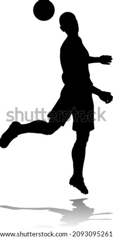 A soccer or football player in silhouette 