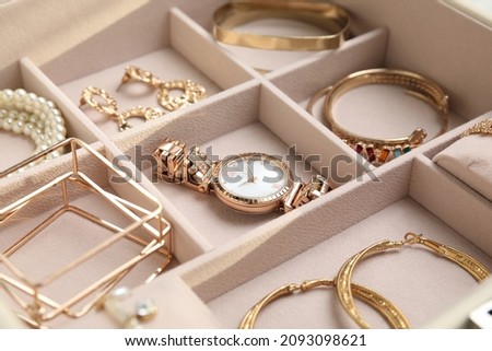 Jewelry box with stylish golden bijouterie, closeup view Royalty-Free Stock Photo #2093098621