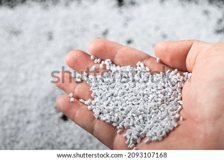 White plastic beads on wood  background, Polymers bead or polymer resin, polymer pallet, Product from petrochemical plants. granules polymer,