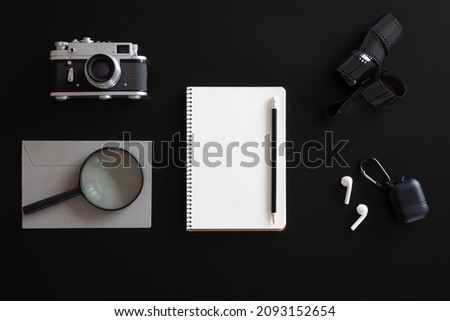 Retro composition with blank notepad on black, flat lay, minimalism.
