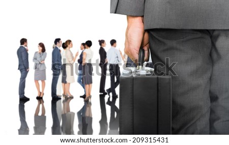 Composite image of businessman holding briefcase against group of workers