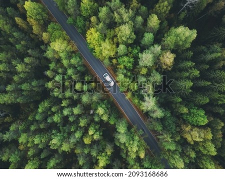 Aerial view asphalt road and green forest. Country road going through forest with car adventure view from above. Ecosystem and ecology healthy environment concept and background. Royalty-Free Stock Photo #2093168686