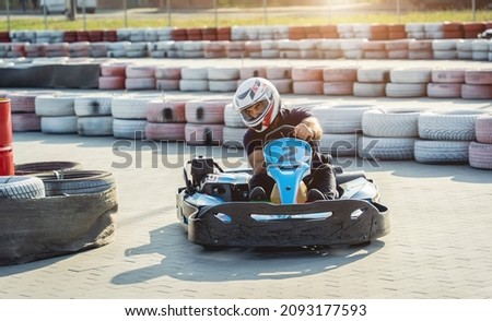 A young man drives a go kart at circuit Royalty-Free Stock Photo #2093177593