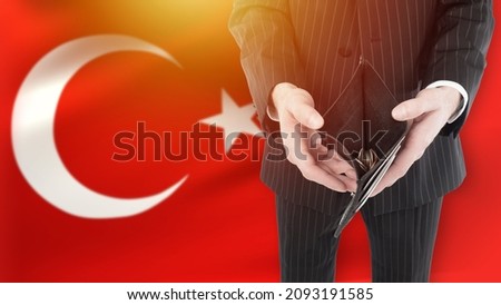 Poverty in Turkey. Crisis and inflation in Turkish republic. Concept of devaluation of national currency of Turkey. Man shows empty wallet. Man bankrupt on background of flag of Turkey. Lira crisis