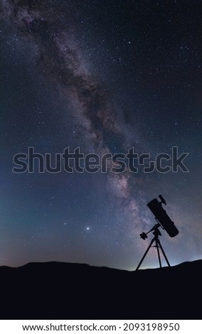 Silhouette of the telescope against the background of the night sky. Astronomical observations of the Milky Way.                       