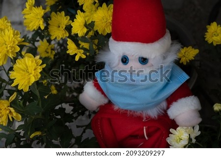santa claus with surgical mask on face to protect from corona virus on 25th December christmas day.