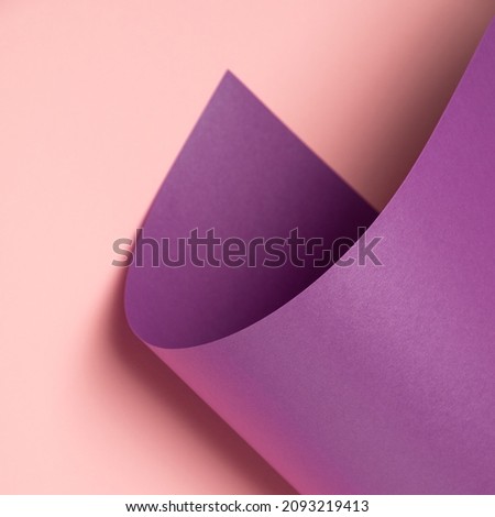 Pastel violet waved paper sheet on a light pink background. Minimal abstract square backdrop