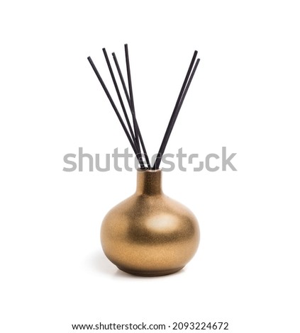 Isolated incense holder with incense sticks. Shiny gold or yellow colored incense vase or incense burner with white background. Used during meditation, religious practice or freshen up the scents. Royalty-Free Stock Photo #2093224672