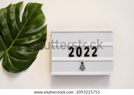  Numbers 2022 on lightbox flat lay, top view with copy space on white background. New year celebration. Happy New Year 2021 concepts
