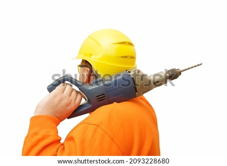 male Builder holding on shoulder a big electric drill. Worker man wearing yellow helmet.  isolated on  white  background