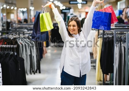 Beautiful woman shopping for clothes at a store