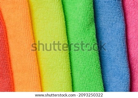 The close up view of colorful fiber towels. The macro view of rainbow colors cloths. There are lgbt  colors. There are red, purple, orange, yellow, green, blue kitchen napkins.