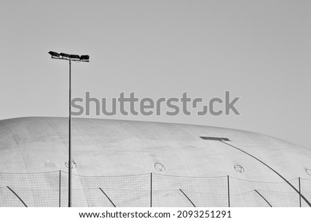 Sports lighting headlights near a pressure switch structure with a plastic cover of a sports building (Pesaro, Italy, Europe)