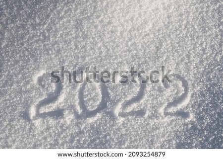 gray background. snow in the photo and the inscription 2022
