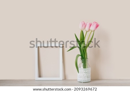 Model In A White Frame With A Pink Tulip In a glass jar with lace. Space for text