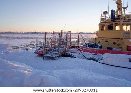 tow ramp at the pier on a frosty sunny winter day on the Severnaya Dvina River in Arkhangelsk. copy space.