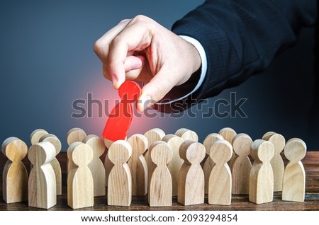 Hand pulls red man out of group. Dismissal, weak link. Identify the culprit among the suspects. Identify the infected person. Zero patient of new strain. Identifying intruder. Collective immunity. Royalty-Free Stock Photo #2093294854
