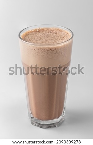 hot chocolate in transparent glass with coffee and frothed milk, whipped cream isolated on a white background, template for summer drink menu of cafe and restaurant