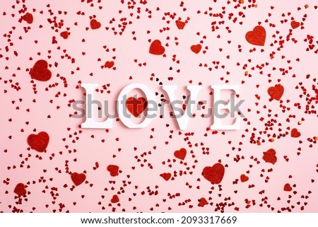 Word Love and red hearts on pink background. Happy Valentines Day concept. Flat lay, top view, overhead.