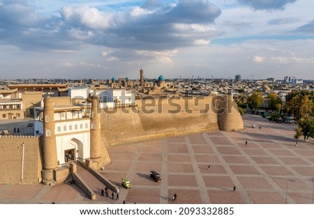 Uzbekistan, Bukhara, the Ark with his atypic walls  is a massive fortress in the historical center of the city. Royalty-Free Stock Photo #2093332885