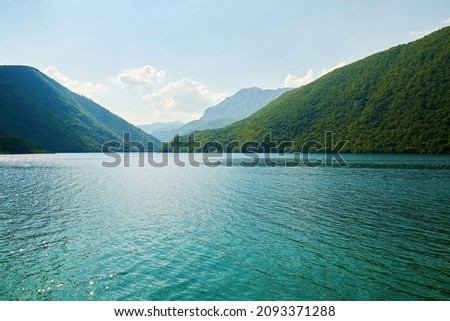 Calm turquoise lake between mountain peaks in Montenegro. Tranquil nature scene