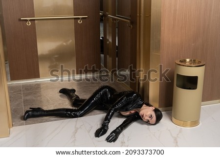 Hit woman. Woman in a latex suit killed in gunfire shot in the chest

 Royalty-Free Stock Photo #2093373700