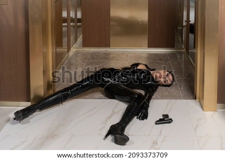 Hit woman. Woman in a latex suit killed in gunfire shot in the chest

 Royalty-Free Stock Photo #2093373709