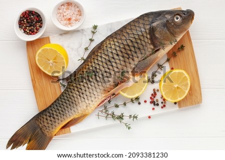 Raw fish carp for preparation for the holiday Christmas on a background. Czech Traditional Christmas Food. Top view
