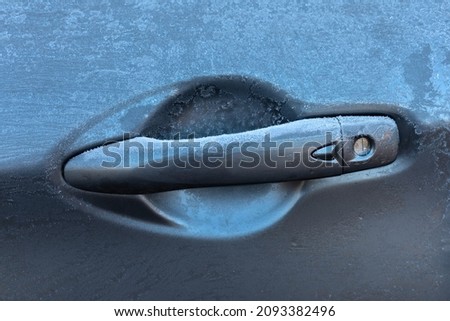 Picture of a frozen  grey car door handle