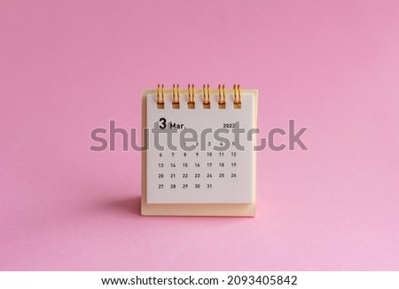 Calendar for March 2022 on a pink background