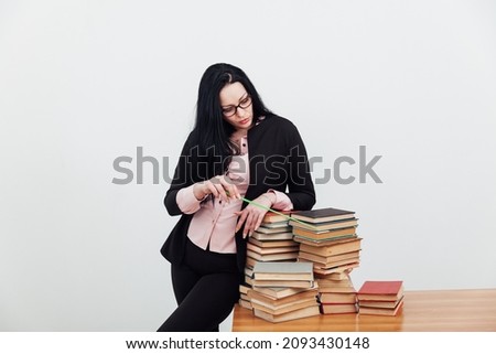 teacher at the table with books for studying at the university