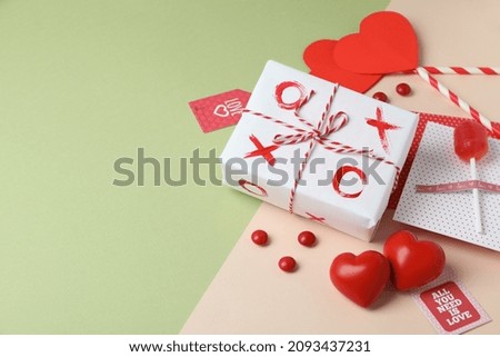 Valentine's Day accessories on two tone background, space for text