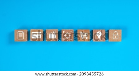 Square wooden blocks on blue background with concept of finance icon.