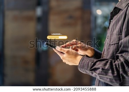 Hand man using mobile smartphone for download application and waiting to loading. Loading icon on screen. businessman downloading digital business data form website and cloud to smartphone Royalty-Free Stock Photo #2093455888
