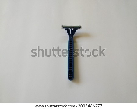 manual mustache trimmer from blue plastic. object position at the center of the photo area