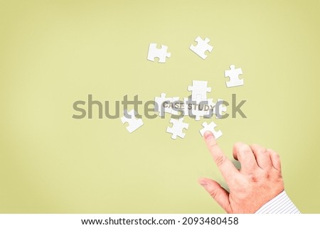A businessman collects the words "Case study" from puzzle pieces. Conceptual photo of the research process, which looks at the development of the situation.