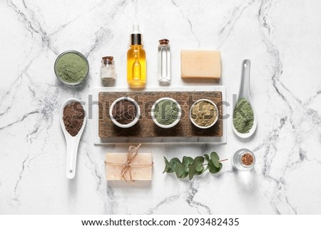 Composition with henna powder and cosmetics on light background